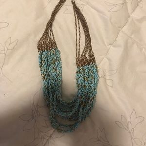 A turquoise and gold necklace.
